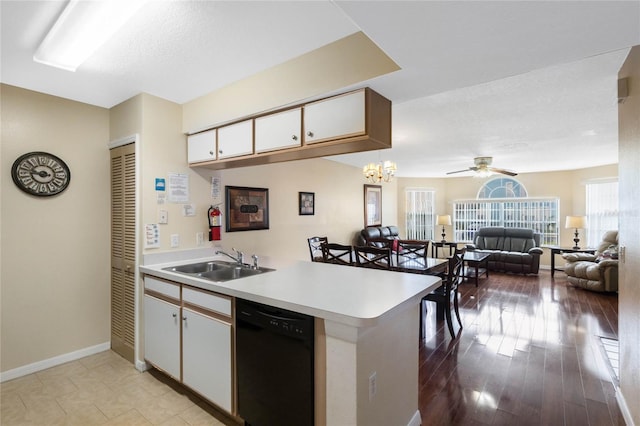 kitchen featuring pendant lighting, white cabinetry, dishwasher, sink, and kitchen peninsula