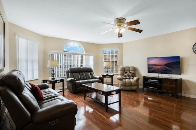 living room with ceiling fan and dark hardwood / wood-style flooring