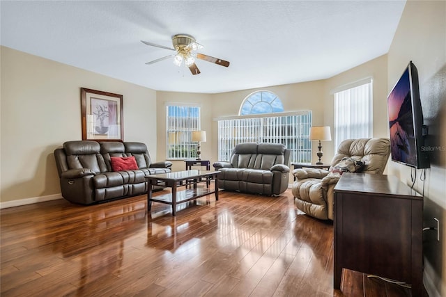 living room featuring dark hardwood / wood-style floors and ceiling fan