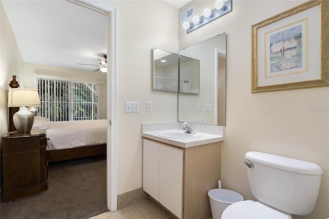 bathroom with vanity, ceiling fan, and toilet