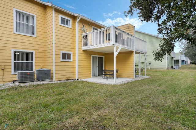 rear view of house featuring a patio, central AC unit, and a lawn