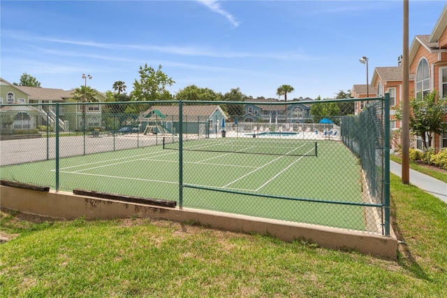 view of sport court with a yard and a playground