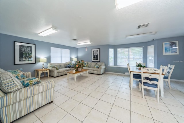 tiled living room with a textured ceiling