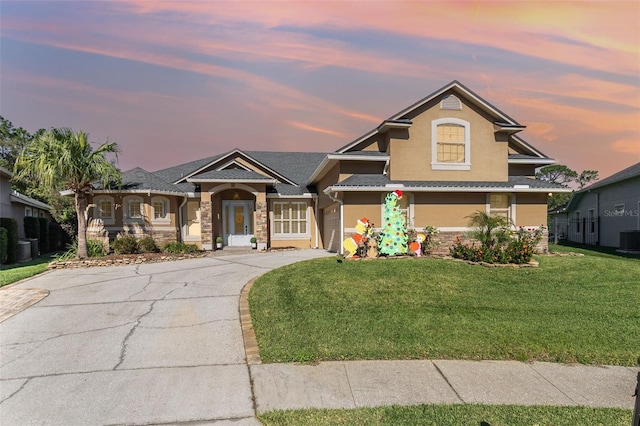 craftsman house with a yard and central AC unit