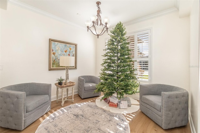 sitting room with crown molding, plenty of natural light, and light wood-type flooring