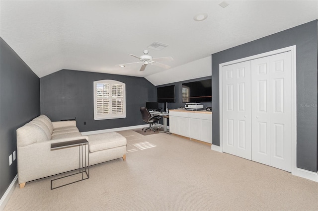 carpeted office space with vaulted ceiling and ceiling fan