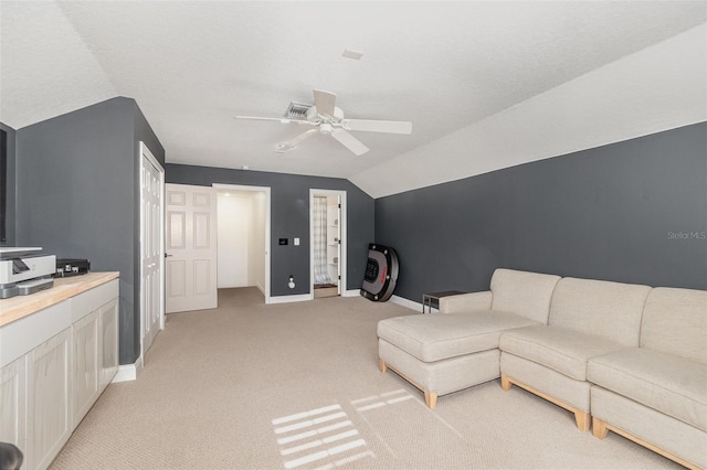 carpeted living room with lofted ceiling and ceiling fan