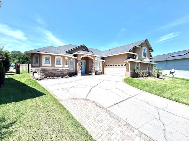 view of front of house with a front yard, stone siding, concrete driveway, and stucco siding