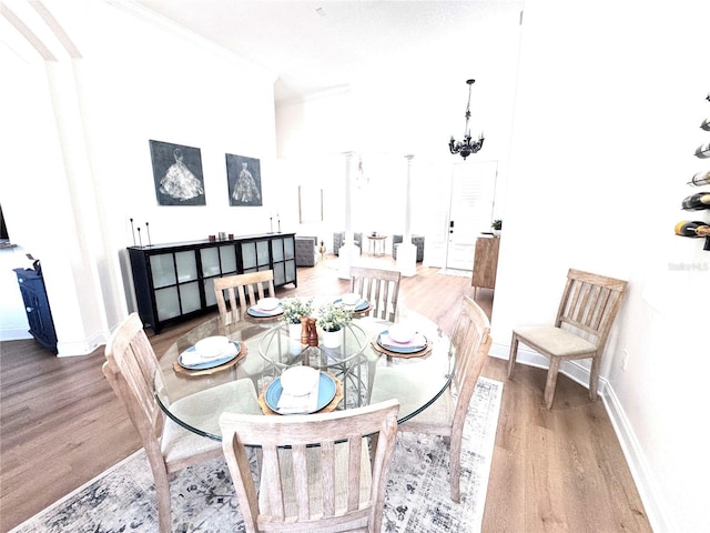 dining room with baseboards, crown molding, and wood finished floors