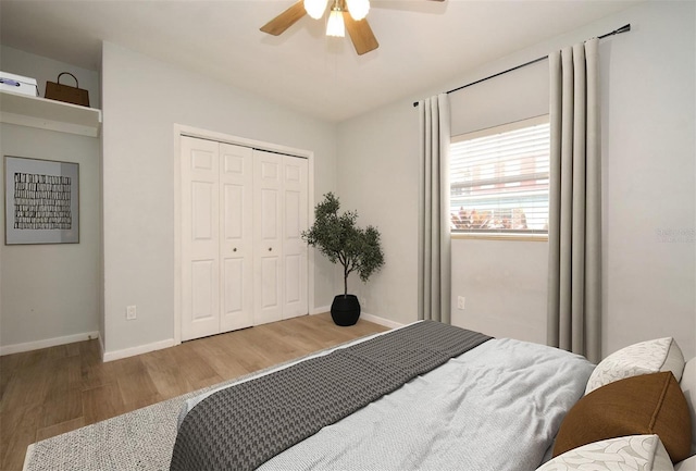 bedroom with hardwood / wood-style floors, ceiling fan, and a closet