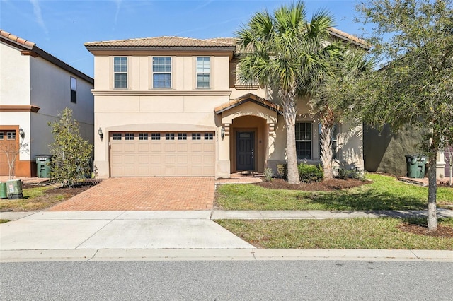 mediterranean / spanish-style home featuring a garage and central AC unit