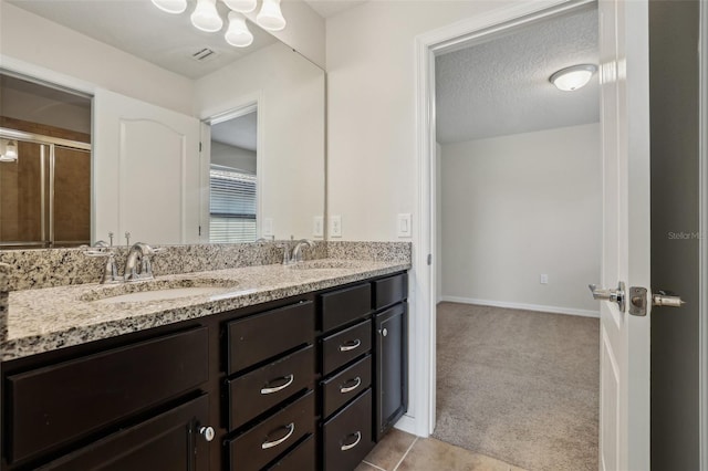 bathroom with vanity and a textured ceiling