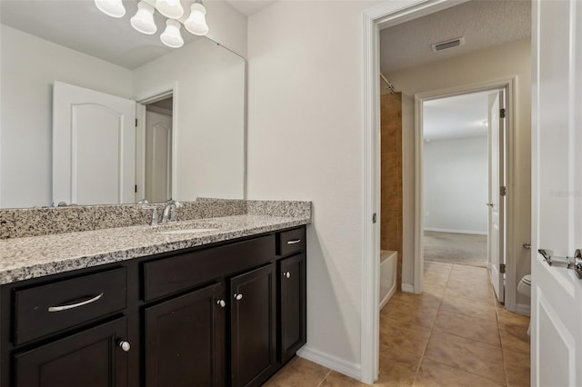 full bathroom featuring  shower combination, an inviting chandelier, vanity, tile patterned floors, and toilet