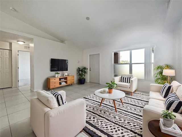 living room featuring lofted ceiling and light tile patterned floors