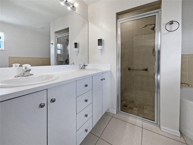 bathroom featuring tile patterned flooring, vanity, and a shower with door