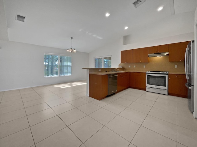 kitchen featuring pendant lighting, stainless steel appliances, tasteful backsplash, vaulted ceiling, and kitchen peninsula