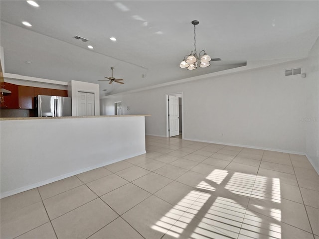 unfurnished room with ceiling fan with notable chandelier and light tile patterned flooring