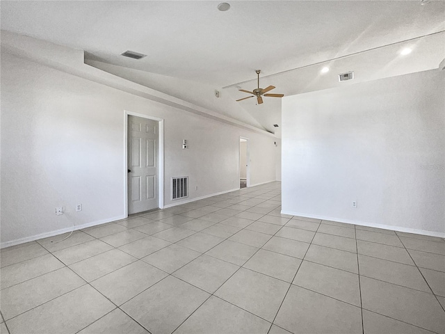 tiled empty room with lofted ceiling and ceiling fan