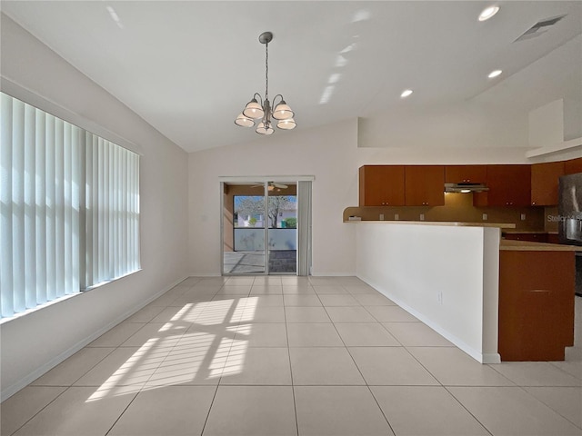 interior space with lofted ceiling, ceiling fan with notable chandelier, and light tile patterned floors