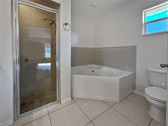 bathroom featuring toilet, separate shower and tub, and tile patterned flooring