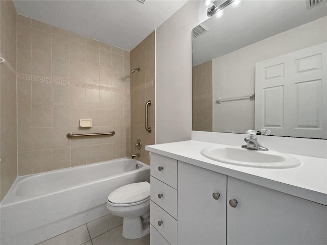 full bathroom with tile patterned flooring, vanity, tiled shower / bath, and toilet