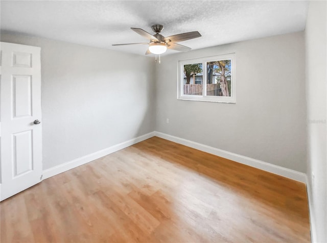 unfurnished room with hardwood / wood-style flooring, a textured ceiling, and ceiling fan