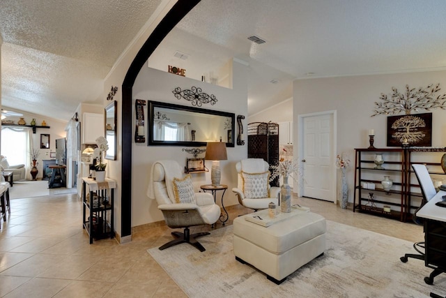 tiled living room featuring lofted ceiling and a textured ceiling