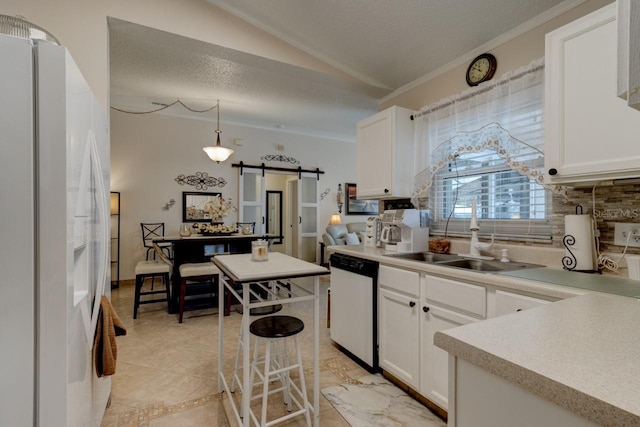 kitchen with white cabinetry, a barn door, dishwasher, and white refrigerator with ice dispenser