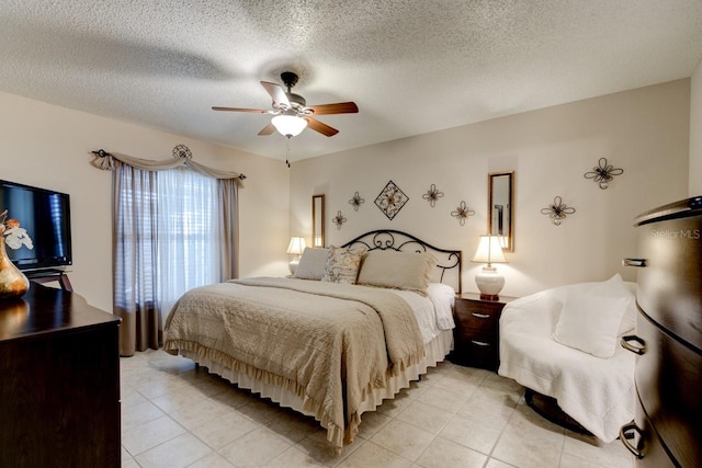 tiled bedroom featuring a textured ceiling and ceiling fan