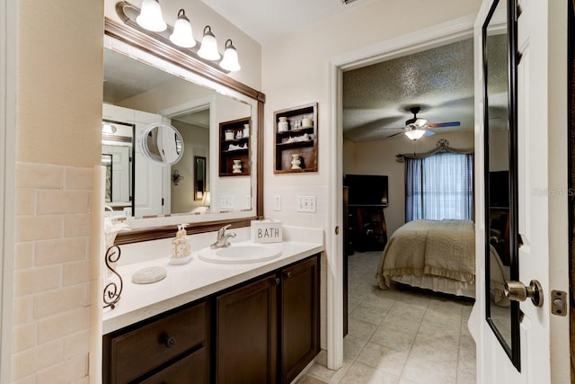 bathroom with vanity, tile patterned floors, ceiling fan, and a textured ceiling