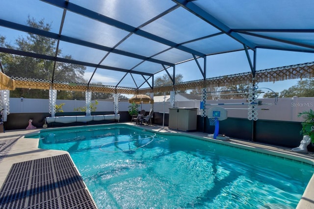 view of swimming pool featuring a patio and glass enclosure