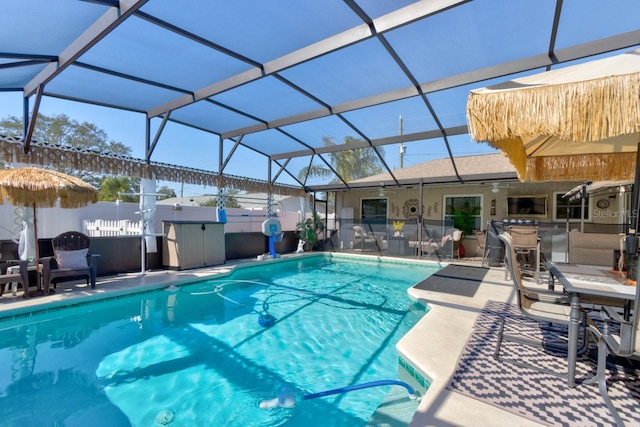 view of pool with a bar, a lanai, and a patio