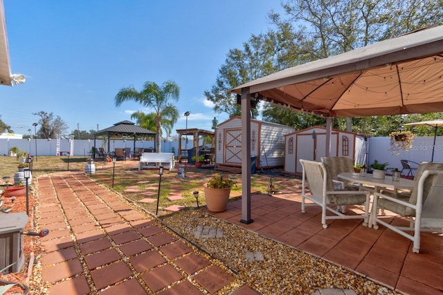 view of patio with a gazebo and a storage unit