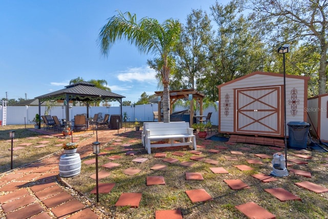 view of yard featuring a gazebo and a storage unit