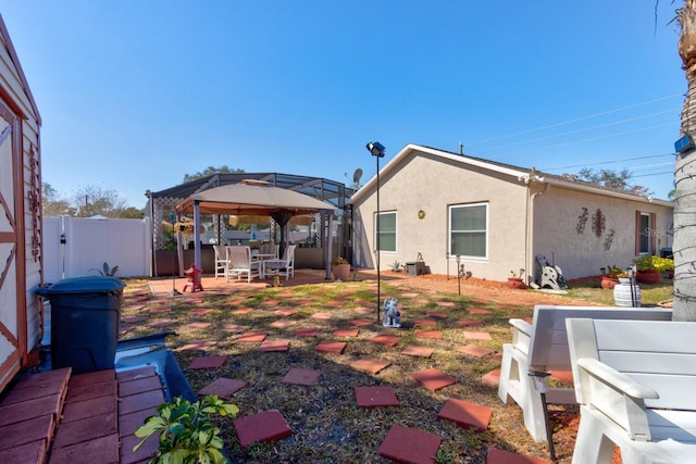 back of house with a gazebo and a patio