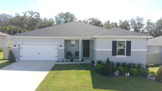 single story home featuring a garage and a front lawn