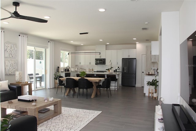 living room featuring ceiling fan and hardwood / wood-style floors