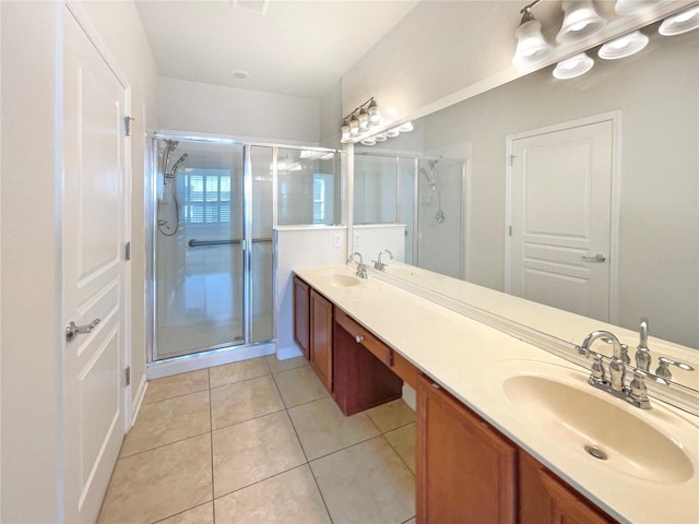 bathroom with tile patterned floors, vanity, and a shower with shower door