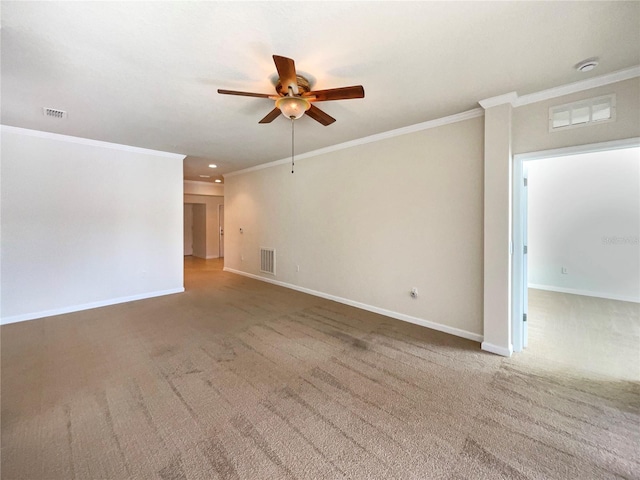 unfurnished room featuring ceiling fan, ornamental molding, and carpet