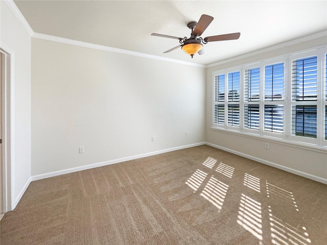 carpeted empty room featuring crown molding and ceiling fan