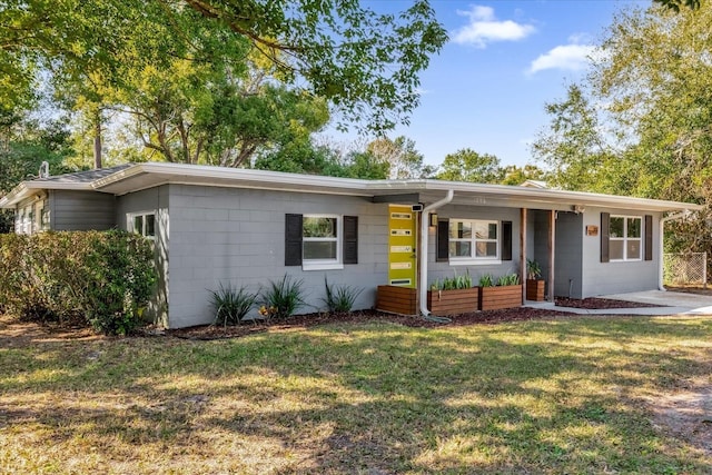 ranch-style home with a front lawn