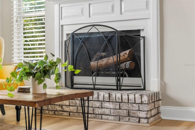 details with hardwood / wood-style floors and a fireplace