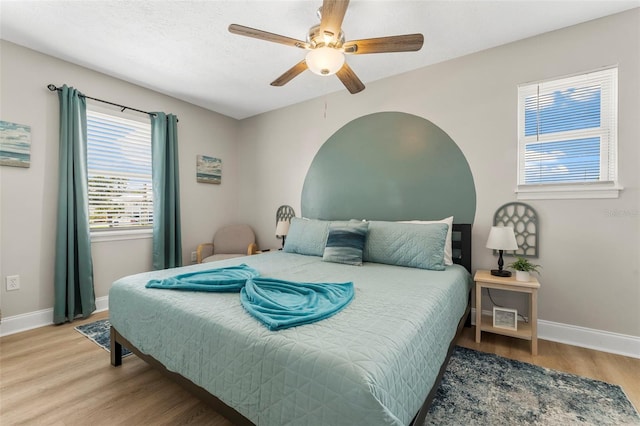 bedroom featuring hardwood / wood-style floors, a textured ceiling, and ceiling fan