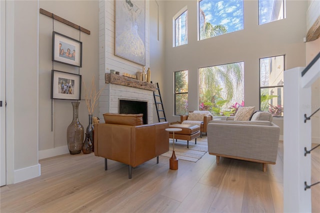 living room with a high ceiling and light wood-type flooring