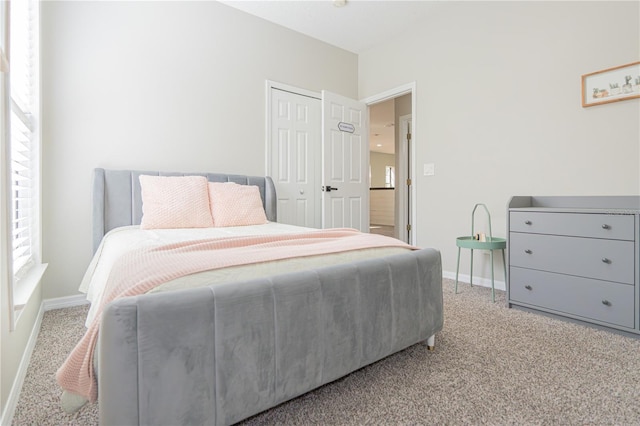 bedroom with light colored carpet and a closet