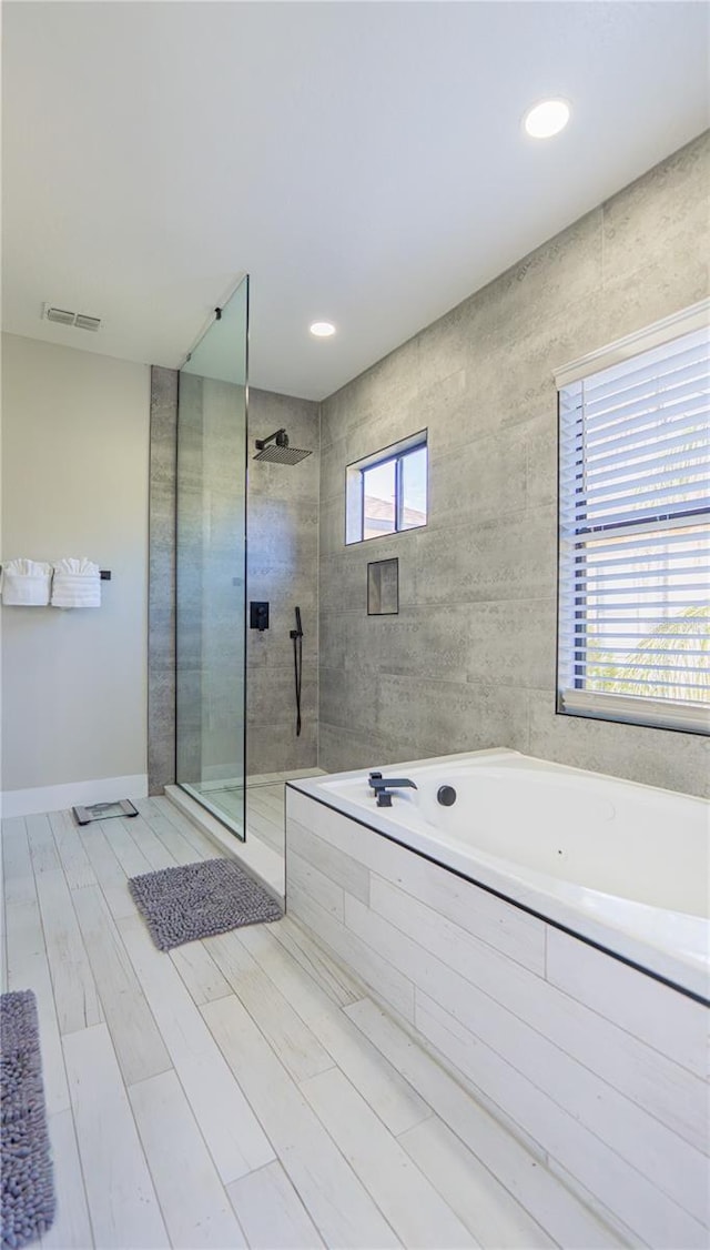 bathroom with separate shower and tub