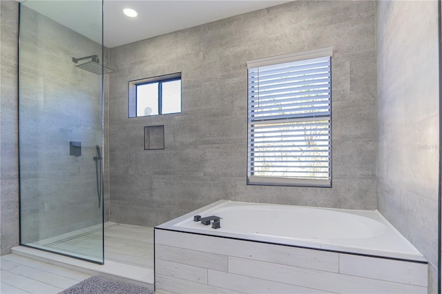 bathroom with tile patterned floors and independent shower and bath