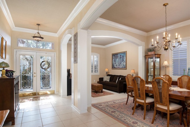 dining space featuring french doors, ornamental molding, light tile patterned flooring, and an inviting chandelier