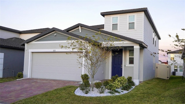 view of front of home with a garage and a yard