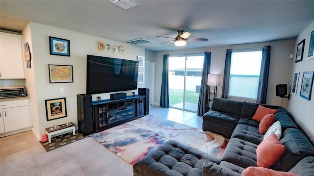 living room featuring light tile patterned floors and ceiling fan